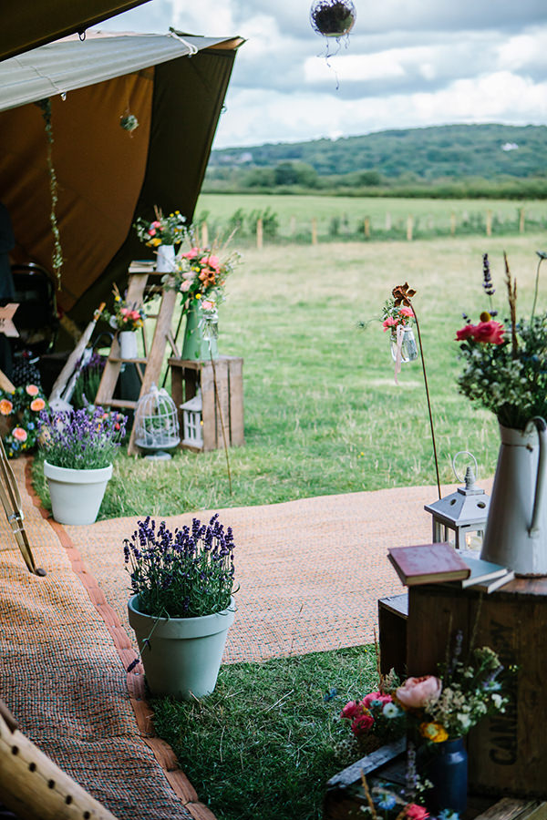 Bohemian Outdoor Tipi Wedding Flowers Ladder Jugs http://www.sarahjanesphotography.co.uk/ 