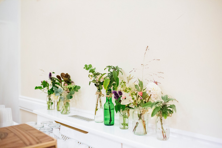 Bottle Flowers Pretty Quirky DIY Village Hall Wedding http://lauradebourdephotography.com/