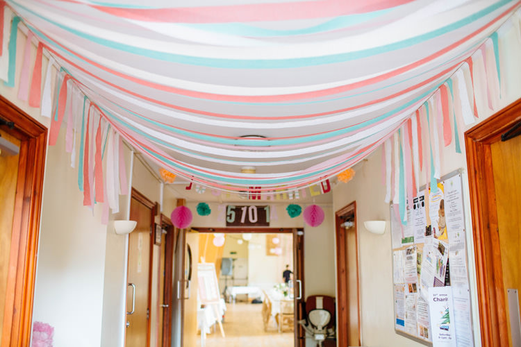 Ribbon Crepe Paper Hanging Ceiling Decor Pretty Quirky DIY Village Hall Wedding http://lauradebourdephotography.com/