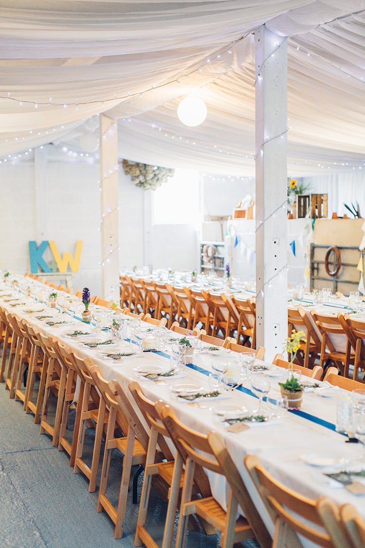 Drapes Bard Fairy Lights Long Tables Wooden Chairs Chilled DIY Beach Front Cafe Cornwall Yellow Blue Wedding http://missgen.com/