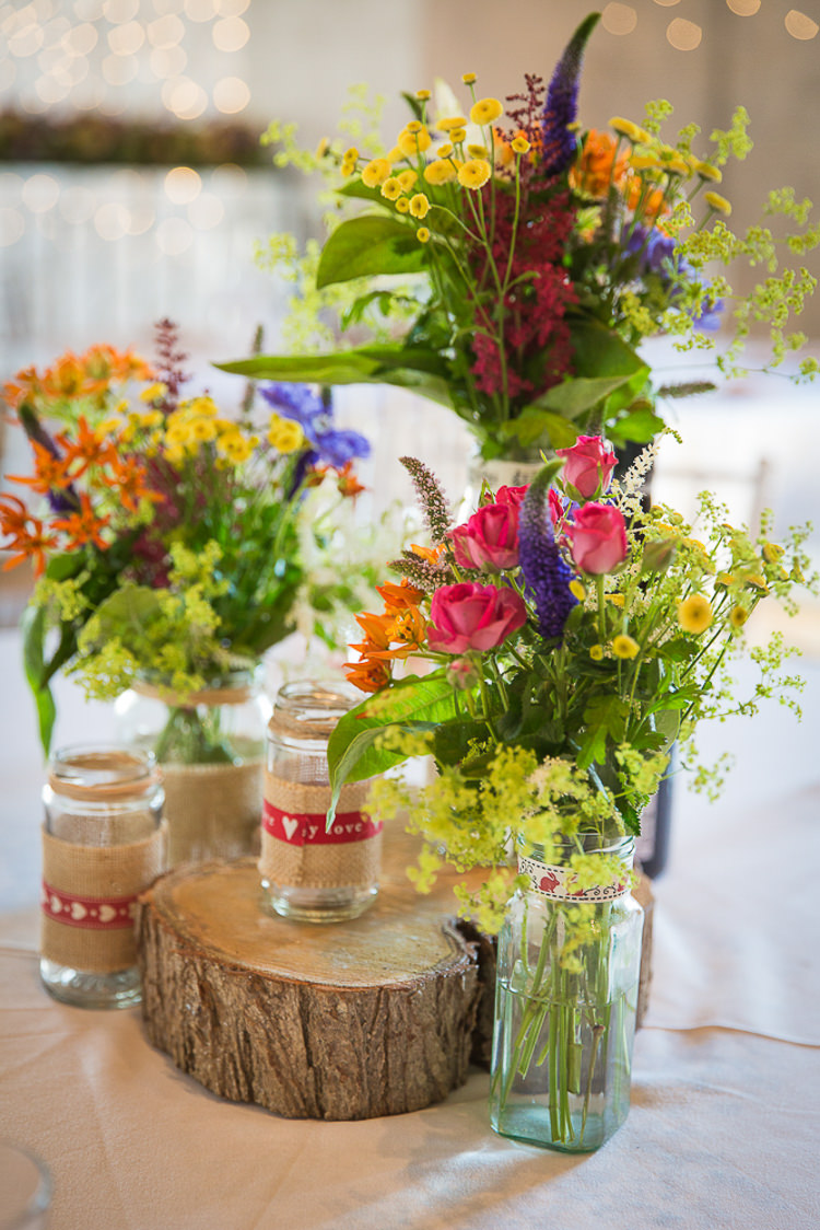 Multi Colour Flowers Wild Logs Jars Centrepiece Colourful Country Barn Street Food Wedding http://www.rocksaltphotography.com/