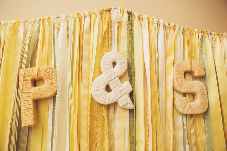 Ribbon Backdrop Letters Initials Quirky Relaxed Yellow Country Wedding http://www.mr-and-mrs-wedding-photography.co.uk/
