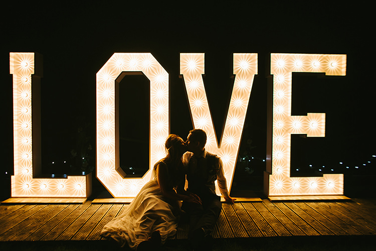 LOVE Letter Lights Stylish Outdoor Tipi Wedding http://www.danhoughphoto.com/