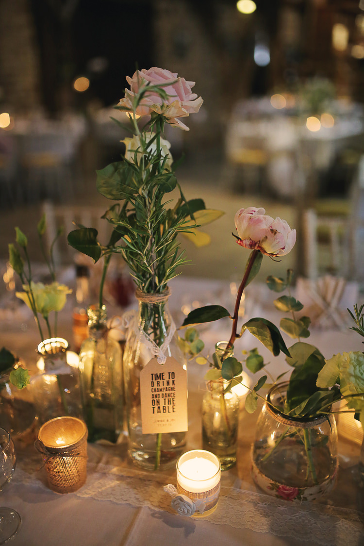 Bottles Jars Flowers Tea Lights Bottles Stylish Pastel Rustic Barn Wedding http://helenrussellphotography.co.uk/ 