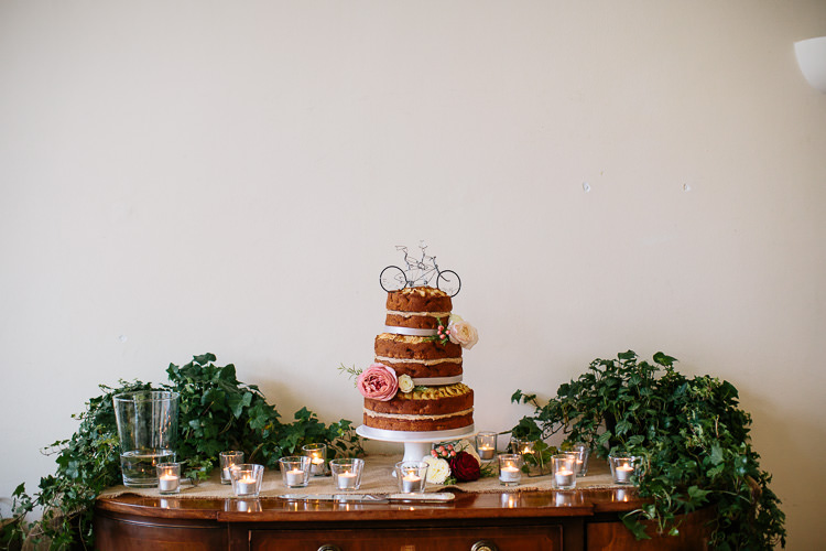 Foliage Greenery Cake Table Candles Bicycle Rich Plum Stylish Relaxed Wedding http://albertpalmerphotography.com/