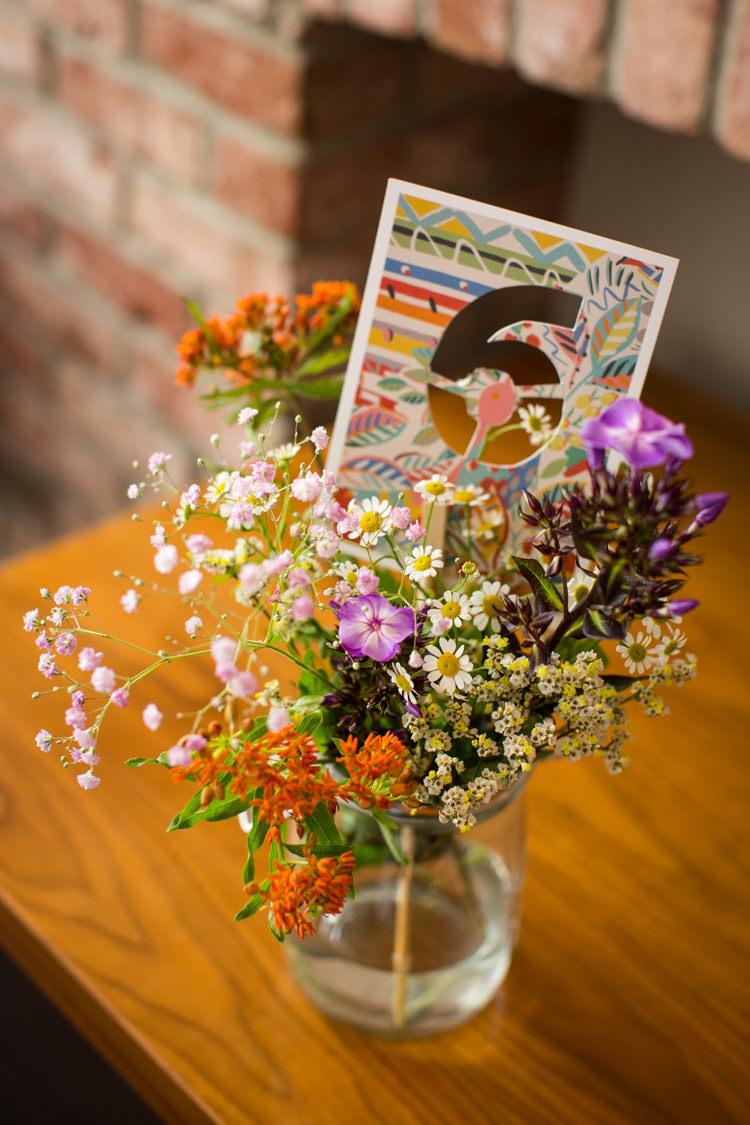 Jar Flowers Wild Blooms Table Numbers Colourful DIY Village Hall Wedding http://samanthagilrainephotography.com/