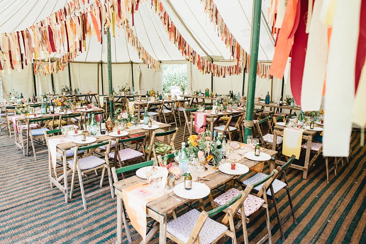 Pole Tent Marquee Rag Bunting Orange Coral Rustic Tables Laid Back Bohemian Festival Wedding http://benjaminmathers.co.uk/