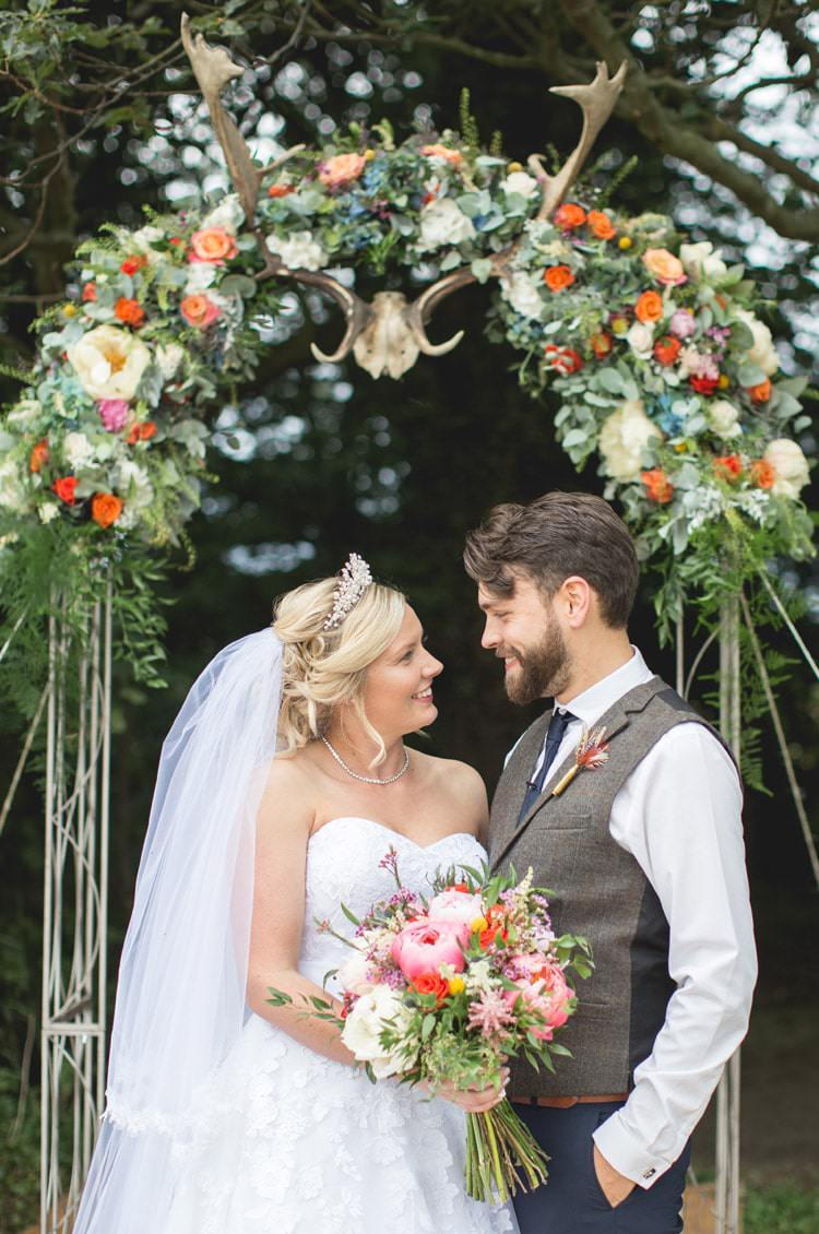 Arch Backdrop Flowers Antlers Family Farm Festival Wedding https://amylouphotography.co.uk/