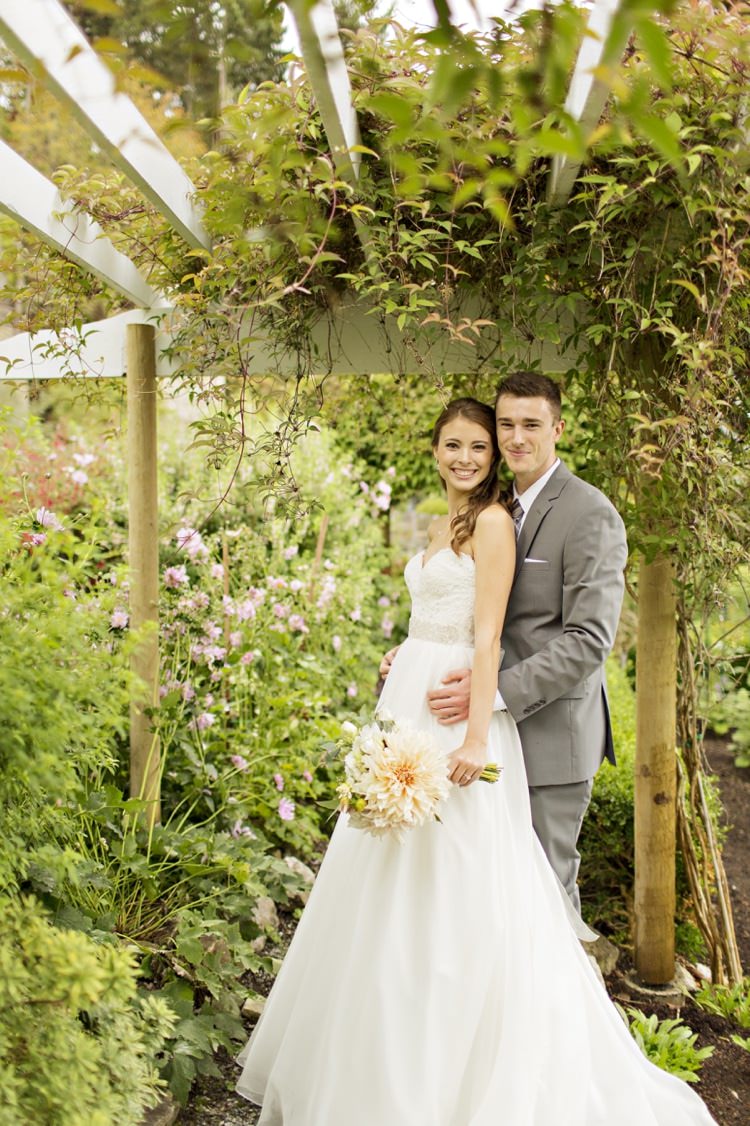 Bride Groom Outdoors Greenery Flowers Strapless Sweetheart Bridal Gown Peach Pink Dahlia Bouquet Grey Suit Elegant Classic Outdoor Wedding Washington http://www.courtneybowlden.com/