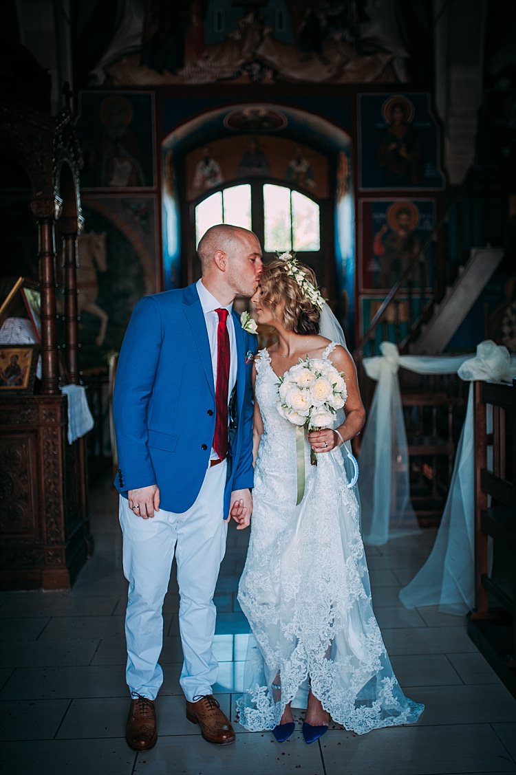 Church Ceremony Bride Stella York Lace Gown Flower Crown Groom Royal Blue Coat Red Tie Beautiful Traditional Greek Destination Wedding in Cyprus http://www.jonnybarratt.com/