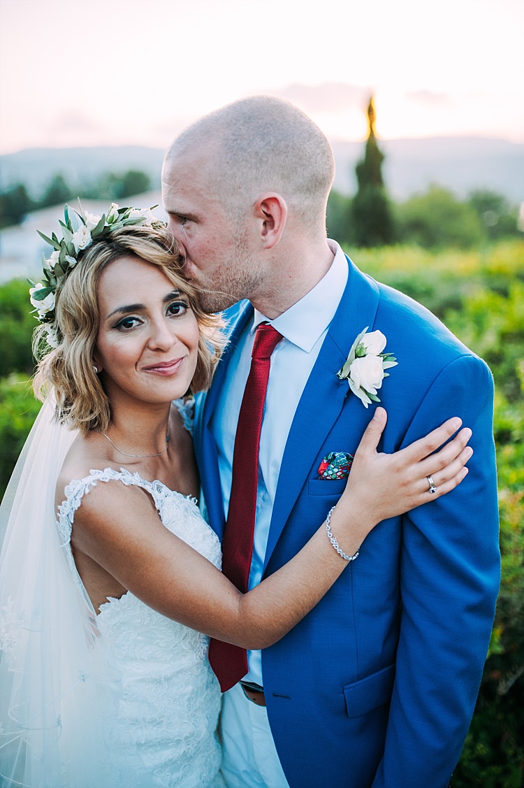 Bride Stella York Lace Gown Flower Crown Veil Groom Royal Blue Coat Red Tie Kiss Beautiful Traditional Greek Destination Wedding in Cyprus http://www.jonnybarratt.com/