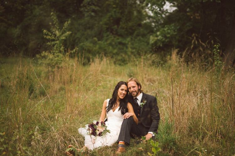 Bride Lace V Neck Bridal Gown Bouquet Cream Maroon Green Flowers Groom Grey Suit Tan Shoes Feather Greenery Button Hole Outdoors Trees Hippy Bohemian Outdoorsy Wedding in Pennsylvania http://tylerboye.com/