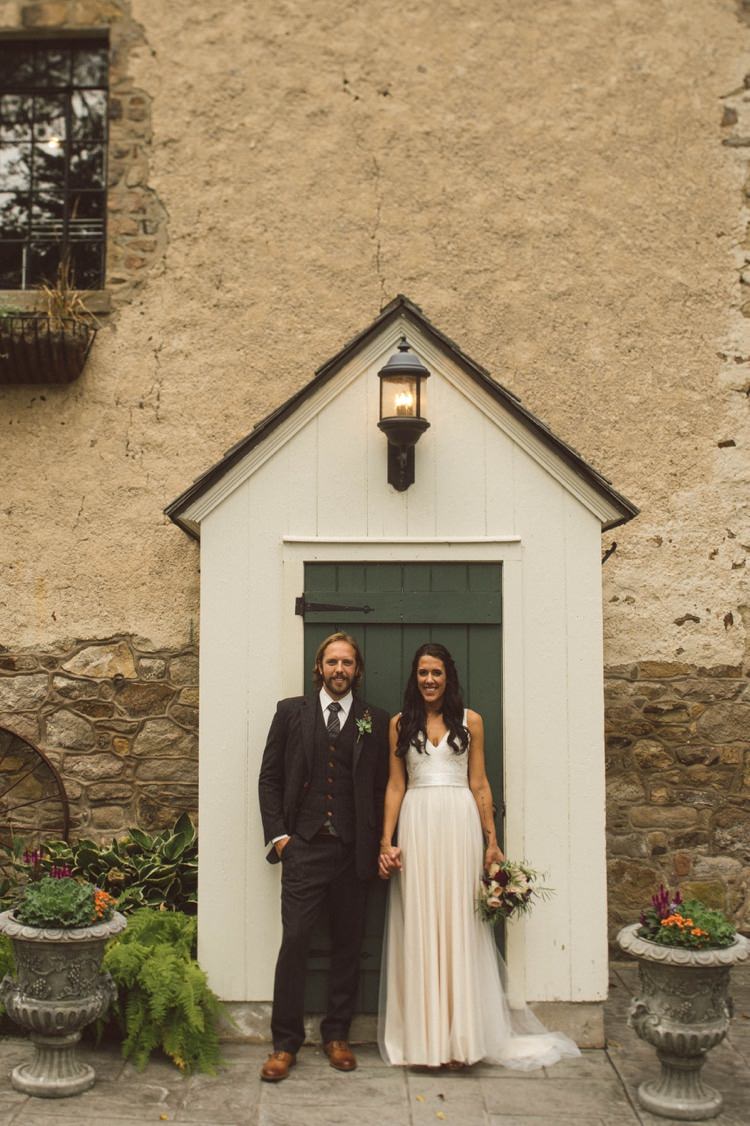 Bride Lace V Neck Bridal Gown Bouquet Groom Grey Suit Vest Tie Tan Shoes Hedge Estate Outdoors Lamp Door Hippy Bohemian Outdoorsy Wedding in Pennsylvania http://tylerboye.com/