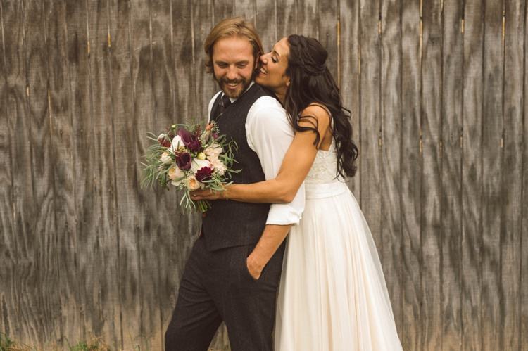 Bride Loose Curls Braid Hairstyle Bouquet Cream Maroon Green Flowers Groom Grey Suit Vest Wooden Wall Hippy Bohemian Outdoorsy Wedding in Pennsylvania http://tylerboye.com/
