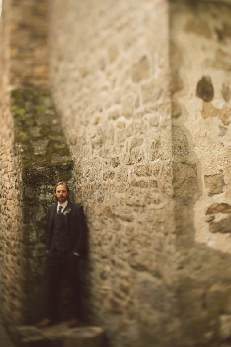 Groom Style Grey Suit Vest Tie Feather Greenery Button Hole Tan Shoes Rock Wall Hippy Bohemian Outdoorsy Wedding in Pennsylvania http://tylerboye.com/