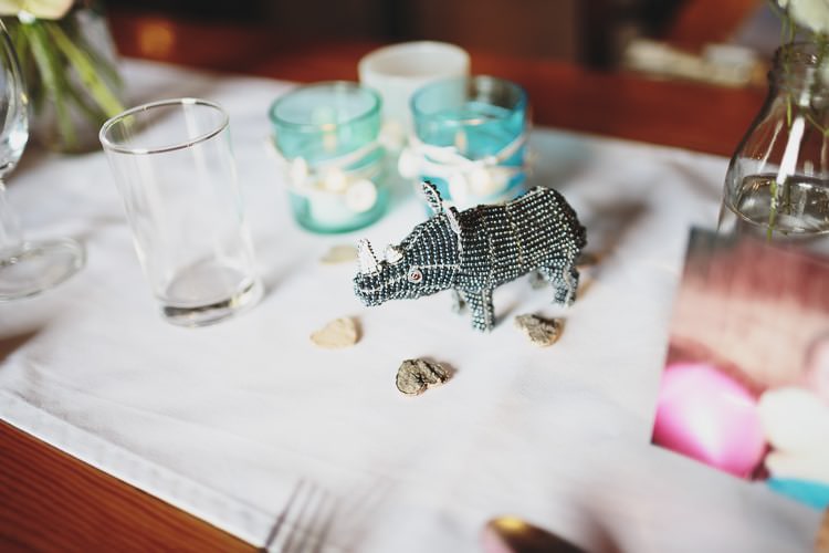 Dinosaur Table Decor Free Spirited Beautiful Beach Wedding https://www.paulfullerkentphotography.com/
