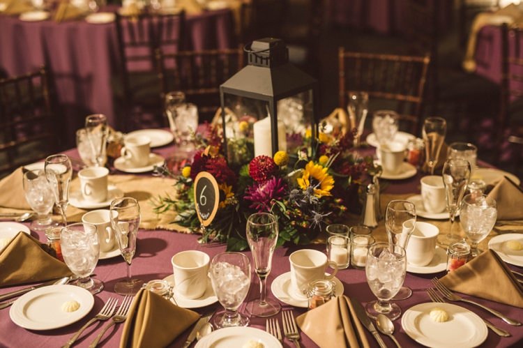 Reception Table Setting Floral Lantern Candle Centrepiece Sunflowers Maroon Greenery Gold Hippy Bohemian Outdoorsy Wedding in Pennsylvania http://tylerboye.com/