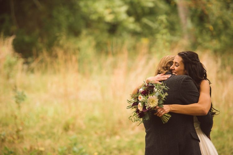 Bride Bouquet Cream Maroon Green Flowers Groom Hug Outdoors Hippy Bohemian Outdoorsy Wedding in Pennsylvania http://tylerboye.com/