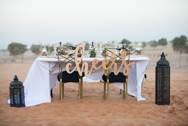 Reception Table Setting Cheers Sign Black White Gold Lantern Sand Geometric Desert Dubai Wedding Ideas http://weddingphotographerdubai.me/