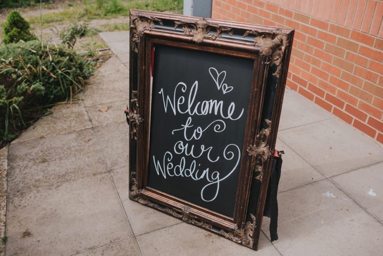 Black Chalk Board Welcome Sign Calligraphy Whimsical Bright Village Hall Wedding http://www.beckyryanphotography.co.uk/
