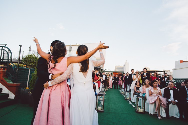 Outdoor Ceremony Celebrant Groom Bride Hugs Guests Modern Roof Terrace Dusk Wedding Madrid http://www.lorenasanjose.com/