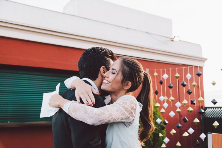 Outdoor Ceremony Groom Bride Hug Hanging Décor Greenery Sunset Modern Roof Terrace Dusk Wedding Madrid http://www.lorenasanjose.com/