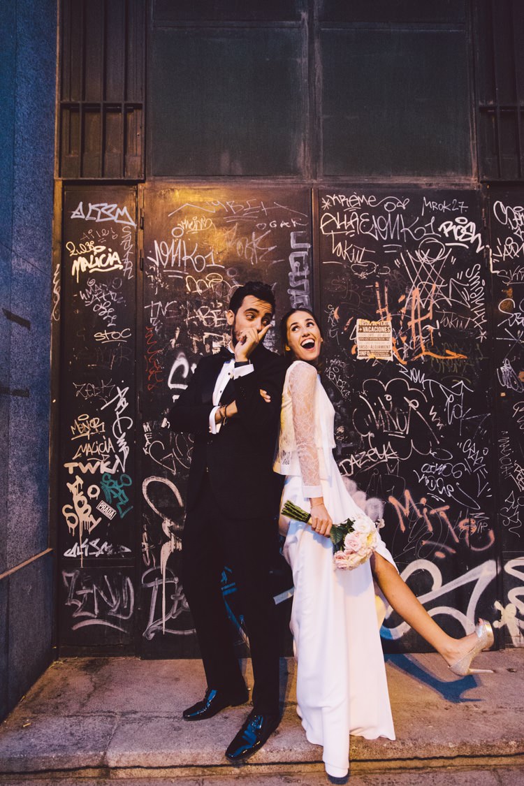Groom Black Suit Bow Tie Bride Three Piece Bridal Gown Low Back Lace City Graffiti Wall Modern Roof Terrace Dusk Wedding Madrid http://www.lorenasanjose.com/