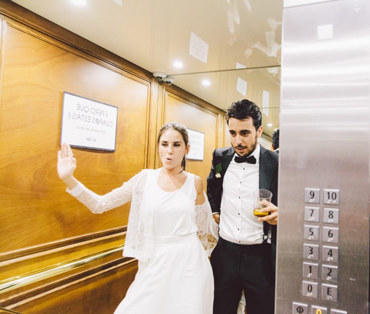 Bride Three Piece Bridal Gown Low Back Lace Groom Black Suit Bow Tie Elevator Drinks Modern Roof Terrace Dusk Wedding Madrid http://www.lorenasanjose.com/