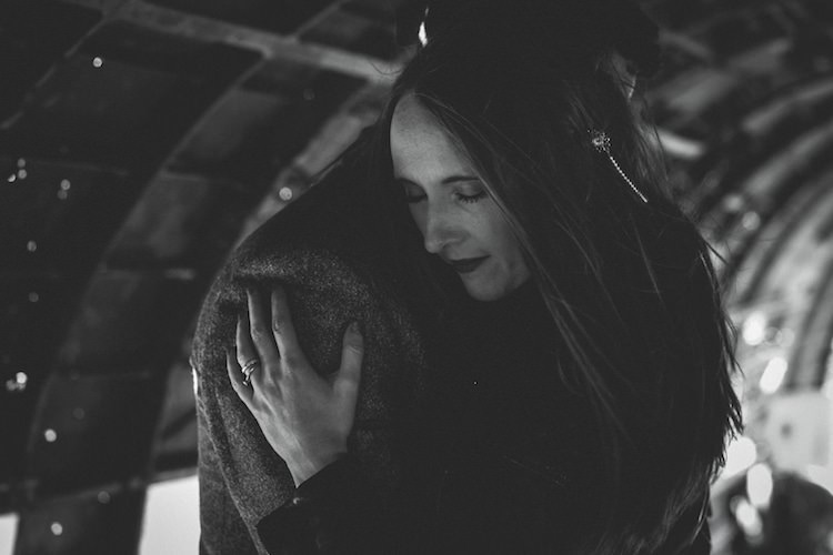 Bride Leather Jacket Pearl Hair Accessory Groom Hug Plane Wreck Glacier Lagoon Iceland Anniversary Shoot http://marcsmithphotography.com/