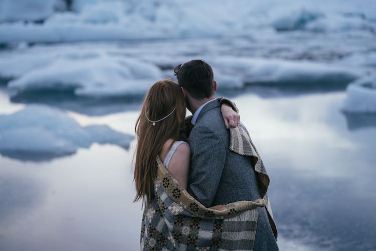 Bride Pearl Hair Accessory Groom Grey Tweed Jacket Blanket Hug Ice Water Glacier Lagoon Iceland Anniversary Shoot http://marcsmithphotography.com/