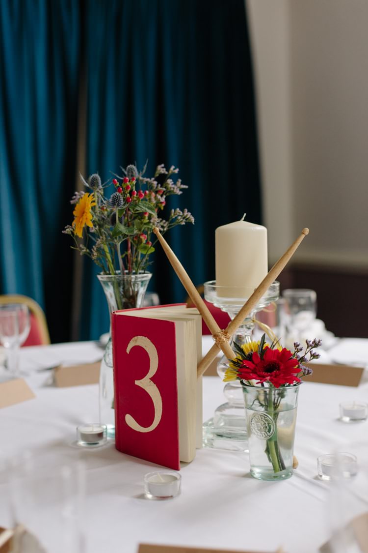 Drumsticks Books Centrepiece Flowers Table Decor Informal Vintage Personal Wedding http://www.marknewtonweddings.co.uk/