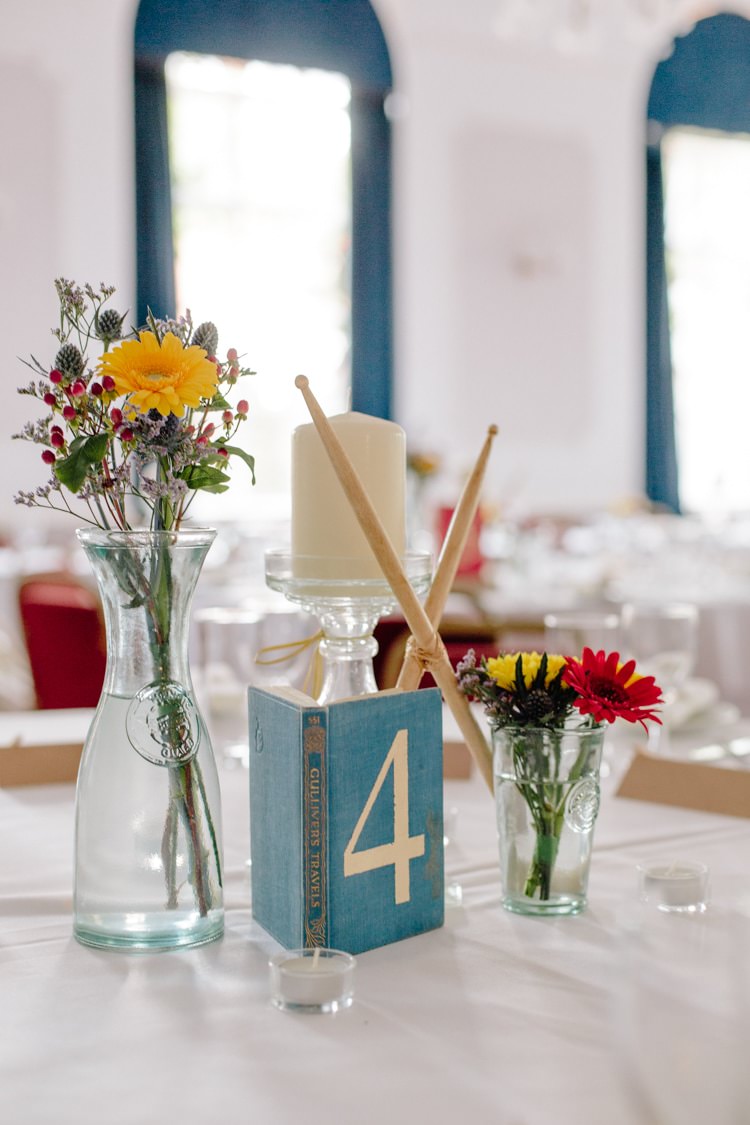 Drumsticks Books Centrepiece Flowers Table Decor Informal Vintage Personal Wedding http://www.marknewtonweddings.co.uk/