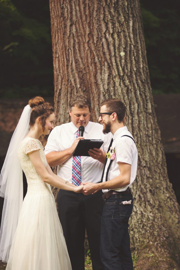 Outdoor Ceremony Bride Cap Sleeve Beaded Gown Veil Groom White Shirt Suspenders Jeans Celebrant Tree Trunk Artistic Whimsical Woodland Wedding http://www.adlivcollective.com/