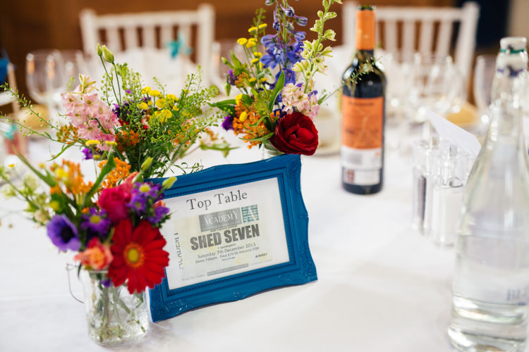 Colourful Bottle Flowers Decor Centrepiece Multicoloured Fun Creative Wedding http://www.catlaneweddings.com/