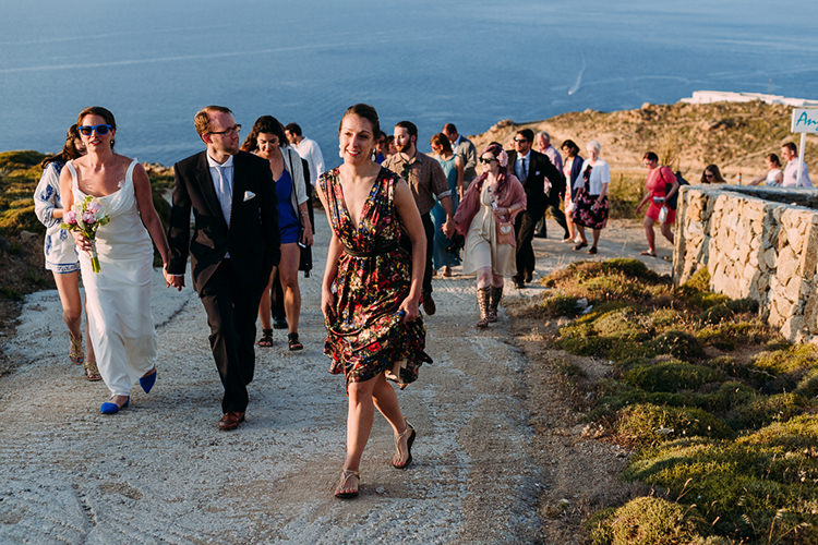Bride Backless Bridal Gown Blue Shoes Sunglasses Groom Navy Suit Blue Striped Tie Wedding Guests Hill Ocean Breathtaking Intimate Mykonos Destination Wedding http://www.annapumerphotography.com/