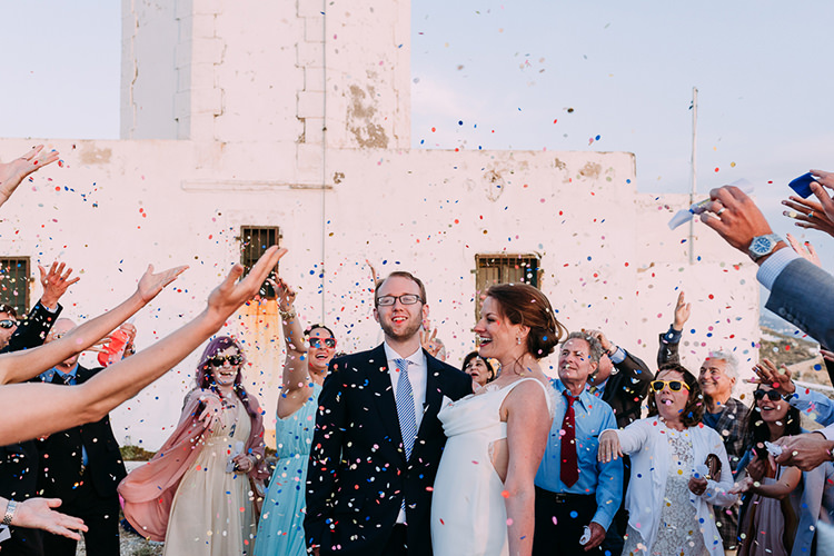Outdoor Ceremony Bride Backless Bridal Gown Groom Navy Suit Blue Striped Tie Guests Confetti Celebrations Breathtaking Intimate Mykonos Destination Wedding http://www.annapumerphotography.com/