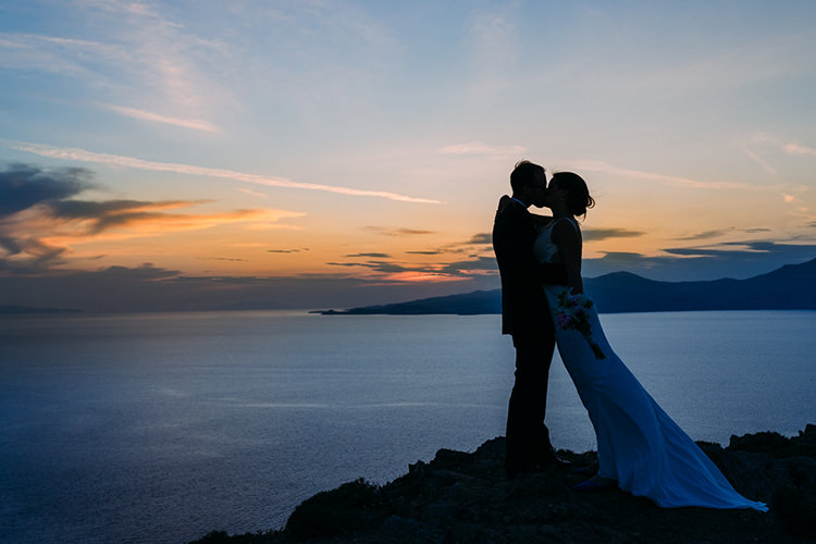Bride Backless Bridal Gown Bouquet Groom Kiss Sunset Ocean Breathtaking Intimate Mykonos Destination Wedding http://www.annapumerphotography.com/