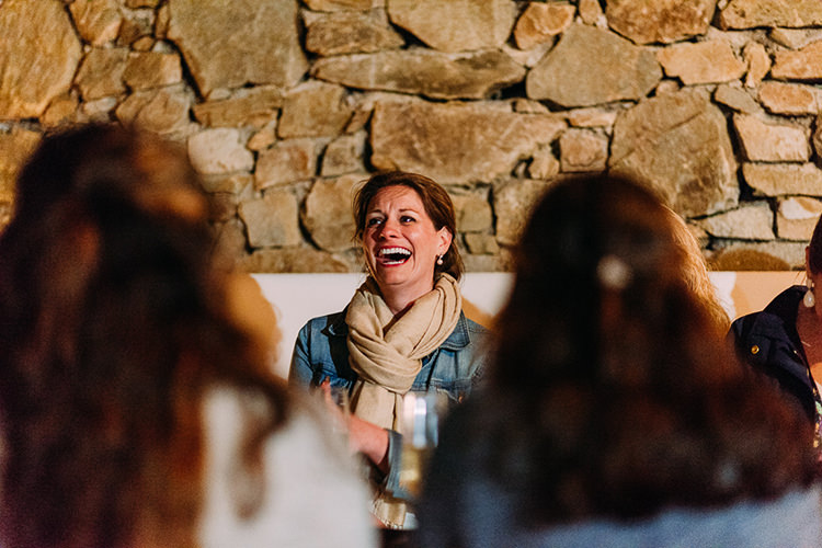 Reception Bride Denim Jacket Scarf Laughter Stone Wall Breathtaking Intimate Mykonos Destination Wedding http://www.annapumerphotography.com/