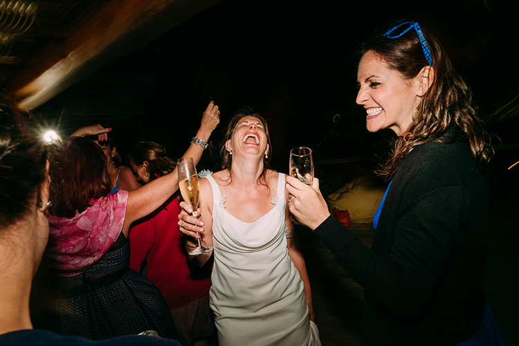 Reception Dancing Bride Backless Bridal Gown Champagne Guests Breathtaking Intimate Mykonos Destination Wedding http://www.annapumerphotography.com/