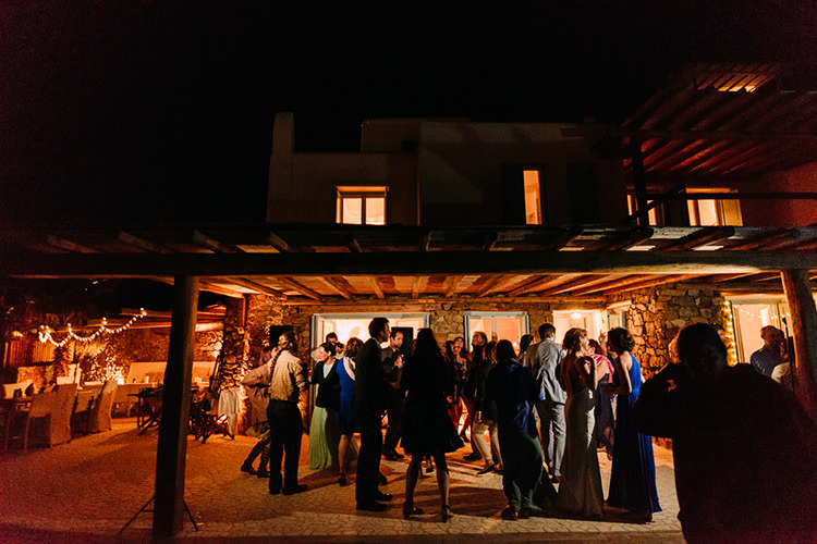 Reception Zinas Villas Guests Outdoors Fairy Lights Breathtaking Intimate Mykonos Destination Wedding http://www.annapumerphotography.com/