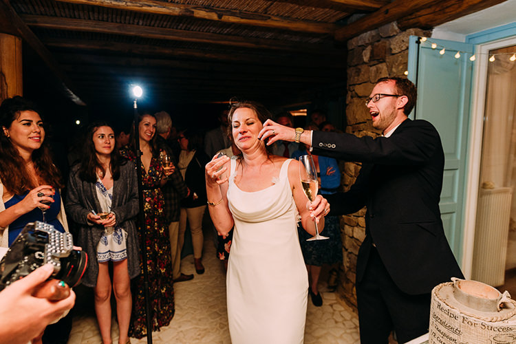 Reception Bride Backless Bridal Gown Groom Navy Suit Champagne Celebrations Guests Breathtaking Intimate Mykonos Destination Wedding http://www.annapumerphotography.com/