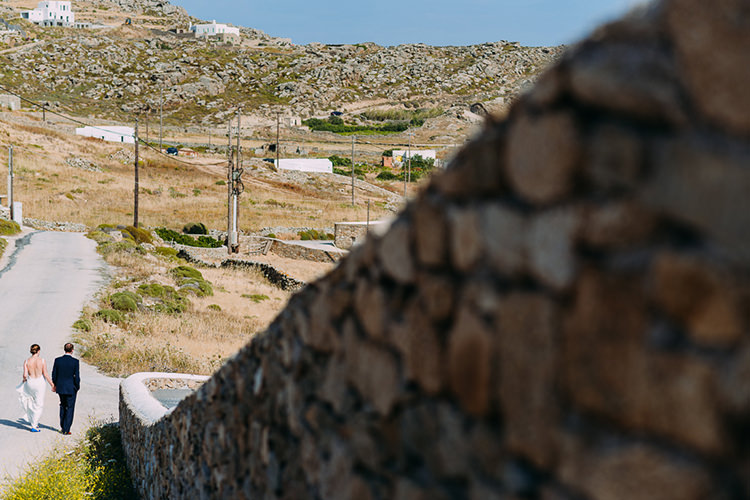 Bride Backless Bridal Gown Groom Island Brick Wall Grass Ocean Breathtaking Intimate Mykonos Destination Wedding http://www.annapumerphotography.com/
