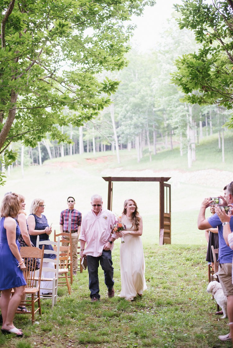 Outdoor Ceremony Bride Chiffon Bridal Gown Father Wooden Doorframe Guests Trees Grass Rustic Woodsy Wedding North Carolina http://abbyleighanne.com/