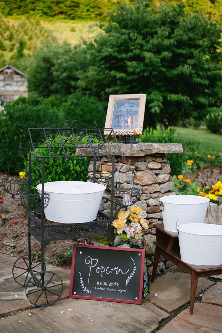 Outdoor Snacks Popcorn Station Different Flavours Blackboard Sign Red Frame Metal Cart Yellow Flowers Rustic Woodsy Wedding North Carolina http://abbyleighanne.com/