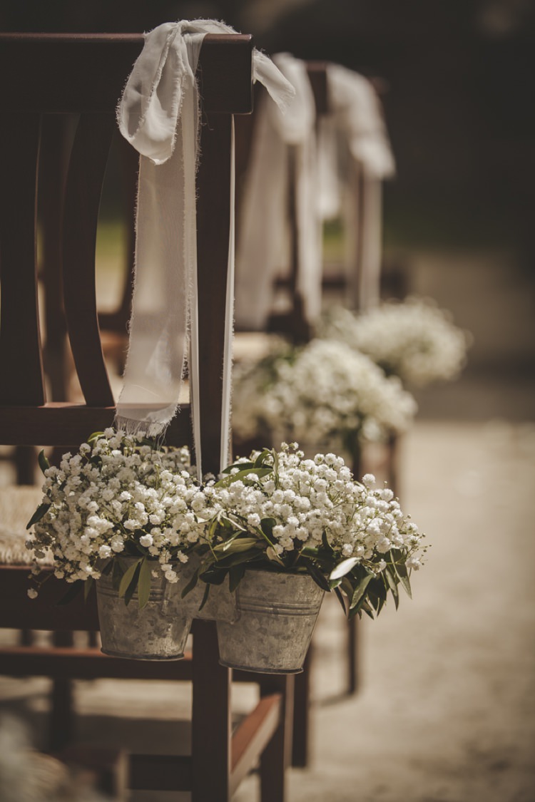 Ceremony Wooden Chairs Gypsophila Metal Buckets White Ribbons Atmospheric Abbey Tuscany Wedding http://www.angelicabraccini.com/