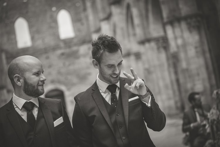 Outdoor Ceremony Groom Polka Dot Tie Groomsmen Navy Blue Suits White Pocket Squares Atmospheric Abbey Tuscany Wedding http://www.angelicabraccini.com/