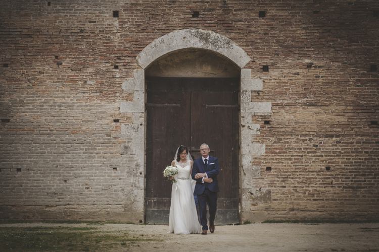 Outdoor Ceremony Bride Lace Sleeveless Bridal Gown Veil Bouquet Father Wooden Door Brick Building Atmospheric Abbey Tuscany Wedding http://www.angelicabraccini.com/