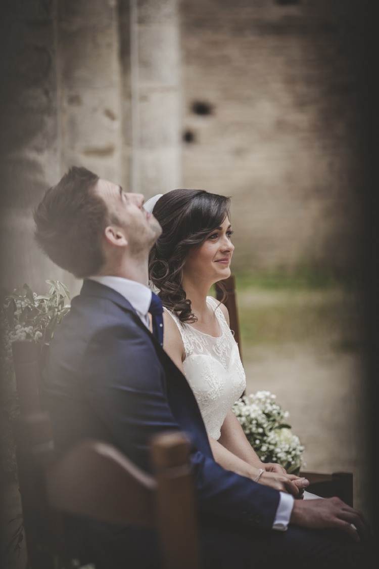 Outdoor Ceremony Bride Lace Sleeveless Bridal Gown Loose Curls Groom Navy Blue Suit Polka Dot Tie Gypsophila Wooden Chairs Atmospheric Abbey Tuscany Wedding http://www.angelicabraccini.com/
