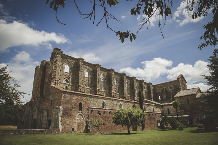 Outdoor Ceremony Location Historic Blue Cloudy Skies Atmospheric Abbey Tuscany Wedding http://www.angelicabraccini.com/