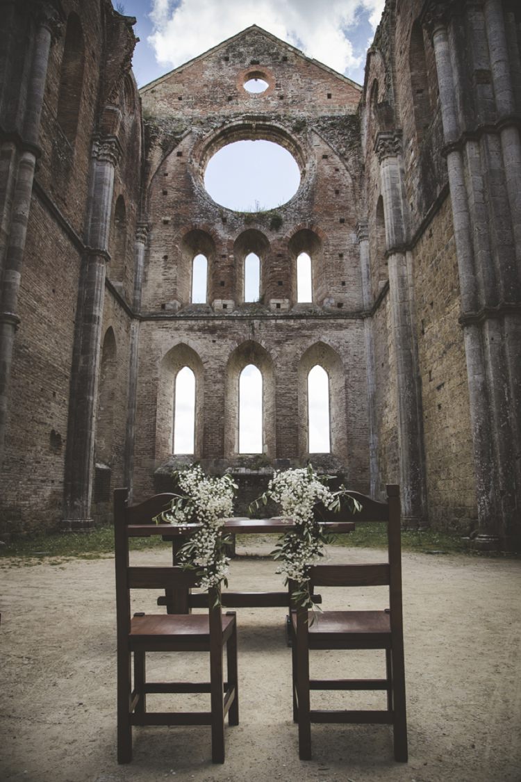 Outdoor Ceremony Historic Location Wooden Chairs Table White Gypsophila Atmospheric Abbey Tuscany Wedding http://www.angelicabraccini.com/